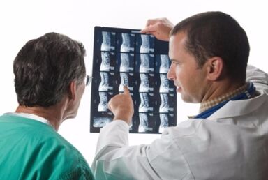 Doctor looks spine